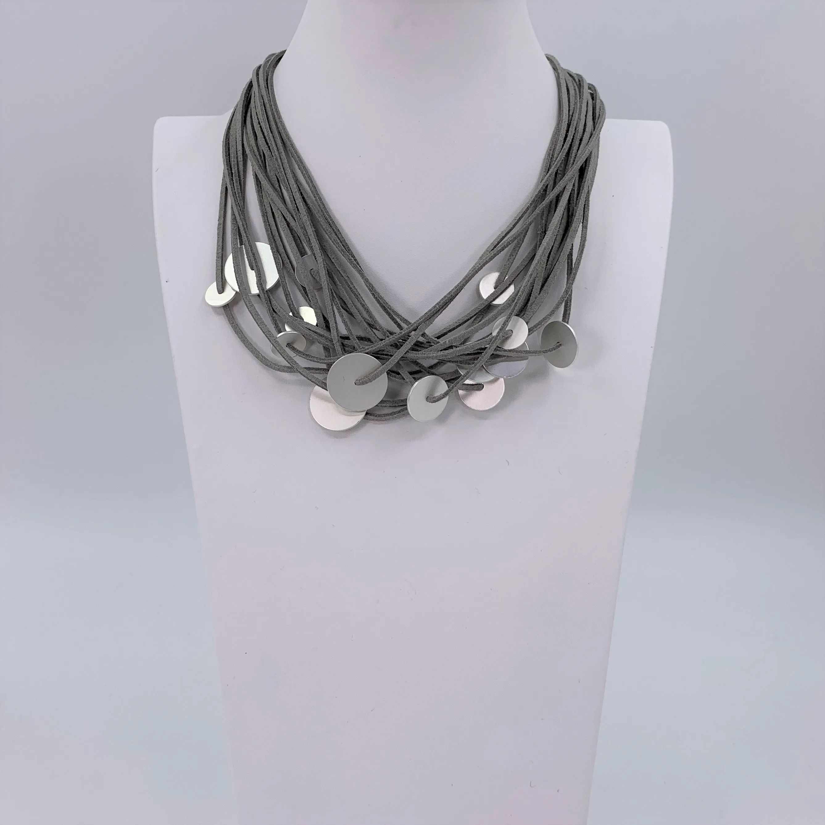 Disc elements on multi faux suede contemporary necklace